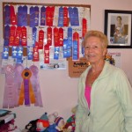 Jonnie Crawford needs another board to hang her knitting ribbons. Photos/Kathryn Reed