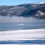 A lone sailboat on Lake Tahoe almost disappears as inversion layers sits on the water Dec. 9. Photo/Kathryn Reed