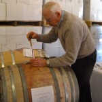 John MacCready taps into the barrel at his Sierra Vista Winery. 