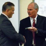 chief City Manager Tony O'Rourke, right, Nov. 2 gives South Tahoe Police Chief Brian Uhler his shield. Photo/Kathryn Reed