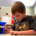 Corey Johnson, 8, works on a coloring project at Under the Magic Pine Tree. 