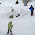 Snowboarders hike a bit to catch a jump under the Grandview chair.