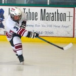 hockey 1 Travis Wood, defense with the Grizzlies Pee Wees, clears the puck from his zone.