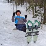 Kae Reed discovers a swing along the snowshoe trail. Photo/Susan Wood