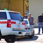 Occupants of the BMW that hit the fire chief's vehicle wait to be be questioned by police officers. Photo/LTN