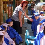 Maria Barrows-Crist helps youngsters to their seats June 17.