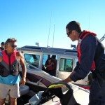 boat-1 Coast Guard Petty Officer Kyle Rahn, right, inspects Kelly Rogers boat.