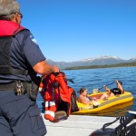 boat-5 Officer Steve O'Brien gives a couple life vests before they paddle to shore.