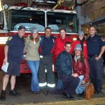 Cindy Trigg, kneeling, and Whittel cheerleaders with New York firefighters.