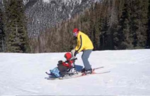 Enlarge image Tilghman Logan and his instructor, Craig Stagg, do some practice turns using sit skis. Some ski resorts have created opportunities for people with disabilities to participate in snow sports. Photo/NPR