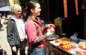 Trying new foods at any age can be a good -- as Veronica Wong introduces her grandmother, Cleo Reed, to street food in China. Photo/LTN file