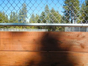 The view of the field from the bottom bleacher seat.
