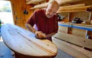 Randall Benton / RBenton@sacbee.com Robbie Jeremica, left, watches as Floyd Smith uses a hand plane to shape a balsa wood surfboard at his home in Rescue . Read more here: http://www.sacbee.com/2013/04/01/5308377/surfboard-legend-still-making.html#storylink=misearch#storylink=cpy