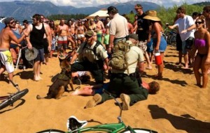 U.S. Forest Service officers on July 4 hold down a man who was in a fight. Photo/Julie Gardner