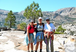 Sue Wood, Kae Reed and Cleo Reed surrounded by wilderness.