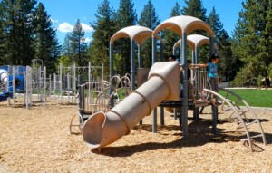 Children play on outdated equipment at Bijou Community School. Photo/Kathryn Reed