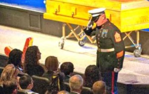 A Marine salutes the family of Marine veteran and Nevada Guard Airman Master Sgt. Michael Landsberry during a memorial service at Sparks Christian Fellowship church Nov. 3. Landsberry was killed Oct. 21, 2013, during a school shooting at Sparks Middle School. Photo by Spc. James Pierce, 106th Public Affairs Detachment