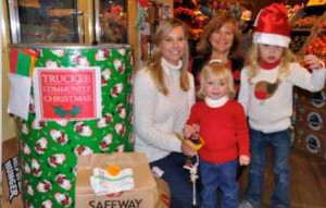 Volunteer Charlene Gamet, top center, along with her daughter and grand-daughters, staffs the Truckee Community Christmas collection barrels to help collect food donations last year at the Truckee Safeway.  