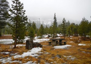 The railroad is on the obscured view of the wall of granite.