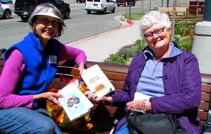 Karen Cutter, left, gives a book to Susanne Wink. Photo/Denise Haerr
