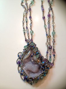 piece is called Ariel's Grotto It is made of a Blue Calcedony Drusy, Fluorite, Swarovski Crystals and Artisan Wire.