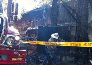 Firefighters on July 24 access the damage to Deerfield Lodge and investigate the cause.