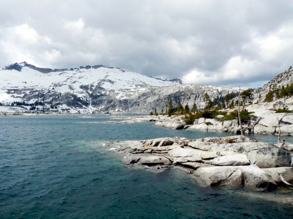 Granite encapsulates the dark blue water of Lake Aloha.