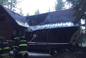 Firefighters mop up at fire the burned the better part of house in Tahoe City. Photo/Provided