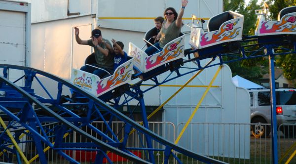 A mini roller coaster delights fair-goers.