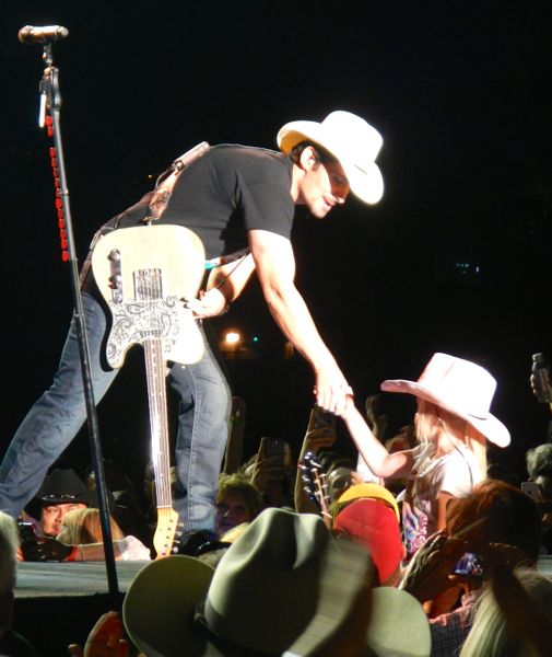 A youngster in the crowd goes home with a Brad Paisley guitar.