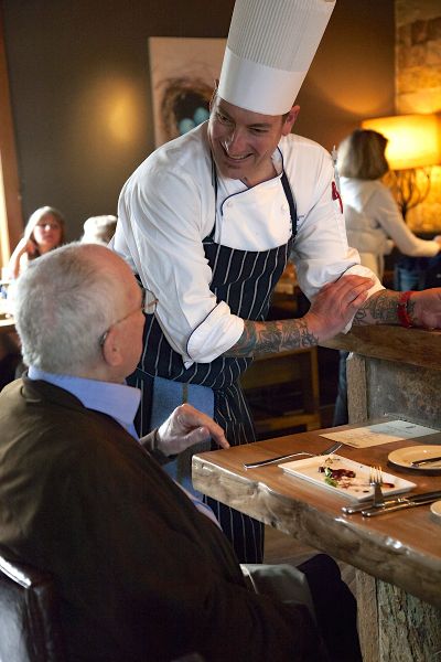 Chef Chris Watkins discusses the meal with Bob Keller. Photo/Carolyn E. Wright/Copyright