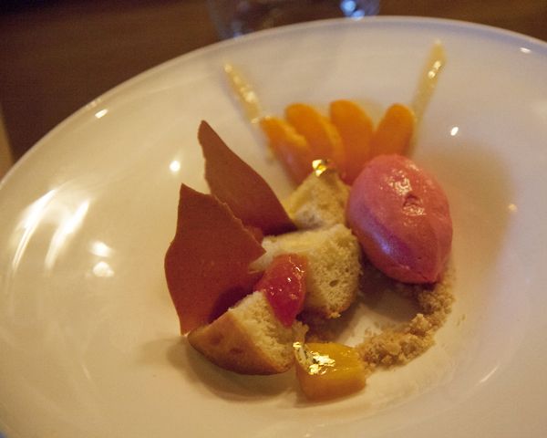 Dessert -- rum baba -- poached peaches, apricot yoghurt sauce, marcona almond cookie crumbs and pum sorbet. Photo/Carolyn E. Wright/Copyright