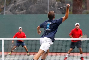Mitch Rittiman goes for a volley against brothers, Jim and Dennis Thorne. Photo/Carolyn E. Wright/Copyright