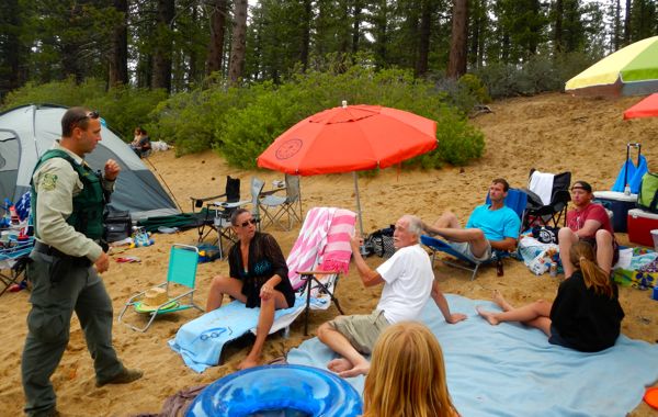 Frank Machler, USFS law enforcement officer. tells a group the beer is not allowed at the beach. Photos/Kathryn Reed