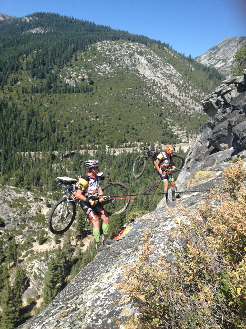 Team Journey, at the time in third place, rappel with their bikes down the cliff. Photo/Provided