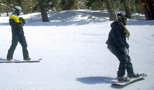 Adaptive Action Sports snowboard coach Chris Koeppe gives Gary Nolte a few pointers as they head down the run. Photo/LTN file