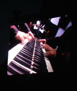Elton John's fingers fly across the ivory.