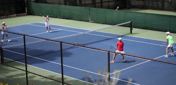 Melissa Jester returns a shot with partner Judy Spellman against Women's 7.0 division champions, Donna Rockwood and Patty Gilliland