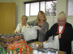 Dana Tucker, Alison Green and Greta Hambsch assemble meals for students in need. Photo/Provided