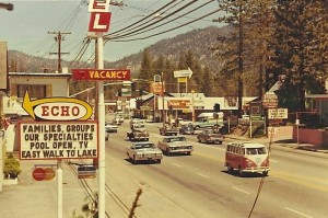 This photo must be later 1960s, as the Echo Motel sign boasts "Master Charge" which was introduced in late 1966 ("Master Charge" changed its brand to "MasterCard" in 1979). This photo was taken from an elevation equal to the second-story window behind the Echo sign, at about where a driveway now enters today's Chevron station on that site. That distant green pickup truck carrying the aluminum boat atop the camper shell is approaching Highway 50 at the same fire hydrant corner as shown in the 1956 photo. Del's Market and the Ski Run Lodge were replaced by the Ski Run Center showing where the Burger Bar fronted Highway 50, approximately where today's Kentucky Fried Chicken stands. At right, the southeast corner of the intersection shows the "3 Swiss Motel and Cottages" and sign, behind which is seen Effie's Dress Shop with its display window atop the mound on the corner. Photo/South Lake Tahoe archives