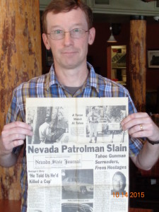 James Gifford holds up newspaper coverage of his father's death. Photo/Provided
