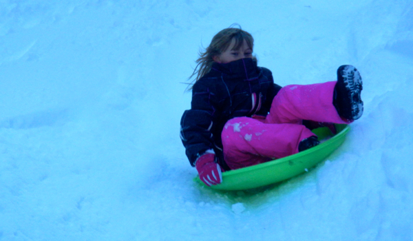 Scarlett Hart hangs on tight Dec. 25 as she sleds near South Tahoe High School. Photos/Kathryn Reed