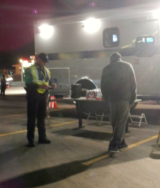 Officer Chris Mahoney leads a man through a series of field sobriety tests.
