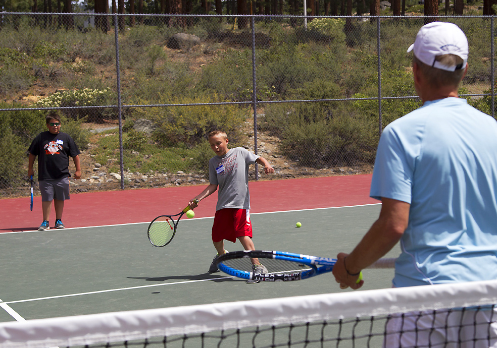 Benn Peterson learns how to hit a forehand from Ross Rittiman. Photo/Provided
