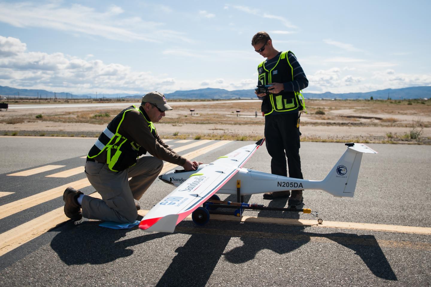 Drone America's Todd Richman, pilot, and Kyle Pruett, engineer and pilot, prepare to test fly the Savant sUAS with cloud seeding flares at the Hawthorne Industrial Airport in Hawthorne, Nev. on Friday, April 29, 2016. The Savant flew to 400 feet and was successful in igniting two silver-iodide cloud seeding flares. CREDIT Kevin Clifford, Drone America