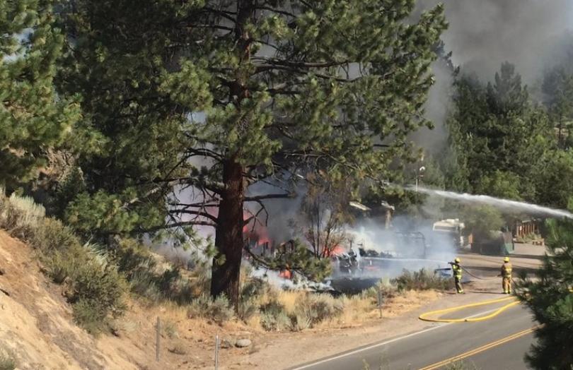 Firefighters work to keep flames from spreading to more buildings at the Carson River Resort. Photo/Jeff Cheetham