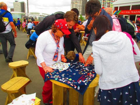 Louise Feller, red hat, trades pins at the London Olympics in 2012. Photo/Provided