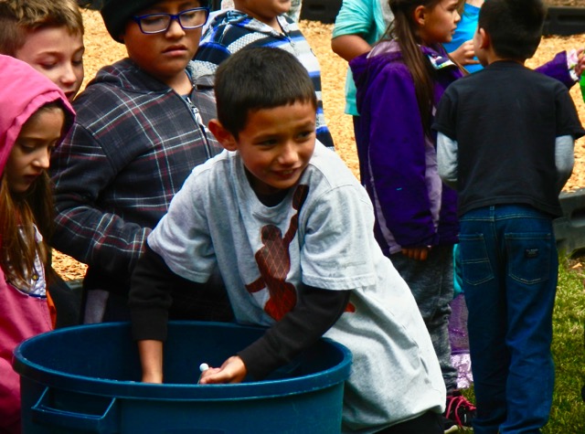 Sierra House second-grader Aeron Pettus helps his team in the water relay competition on Oct. 3. Photo/Kathryn Reed