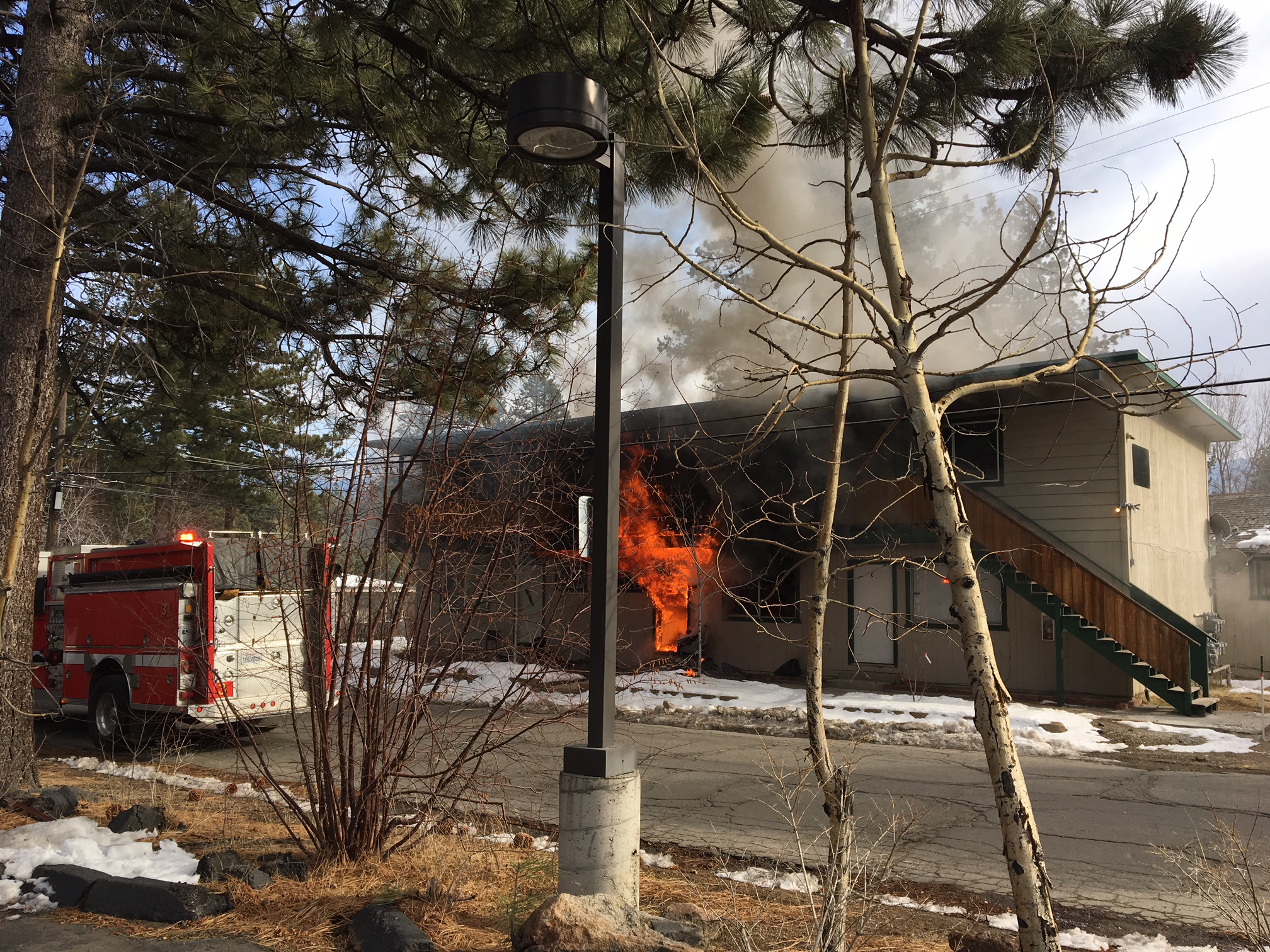 Flames shoot out from a South Lake Tahoe apartment on Dec. 7. Photo/Provided