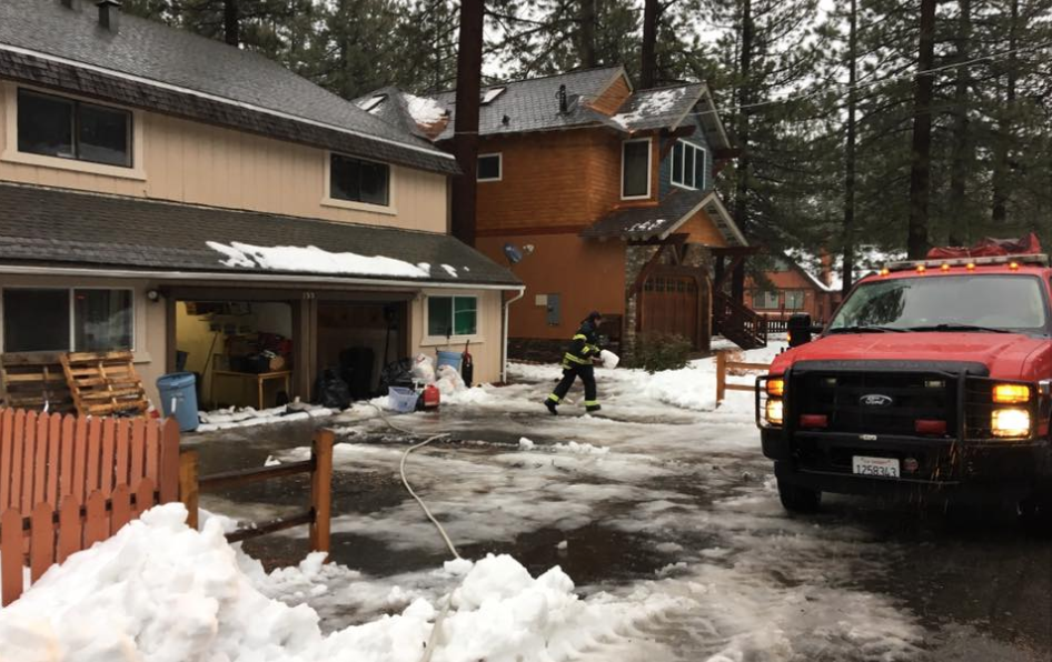 South Tahoe firefighters respond to water in a garage. They use a sump pump to clear the area. Photo/Provided 